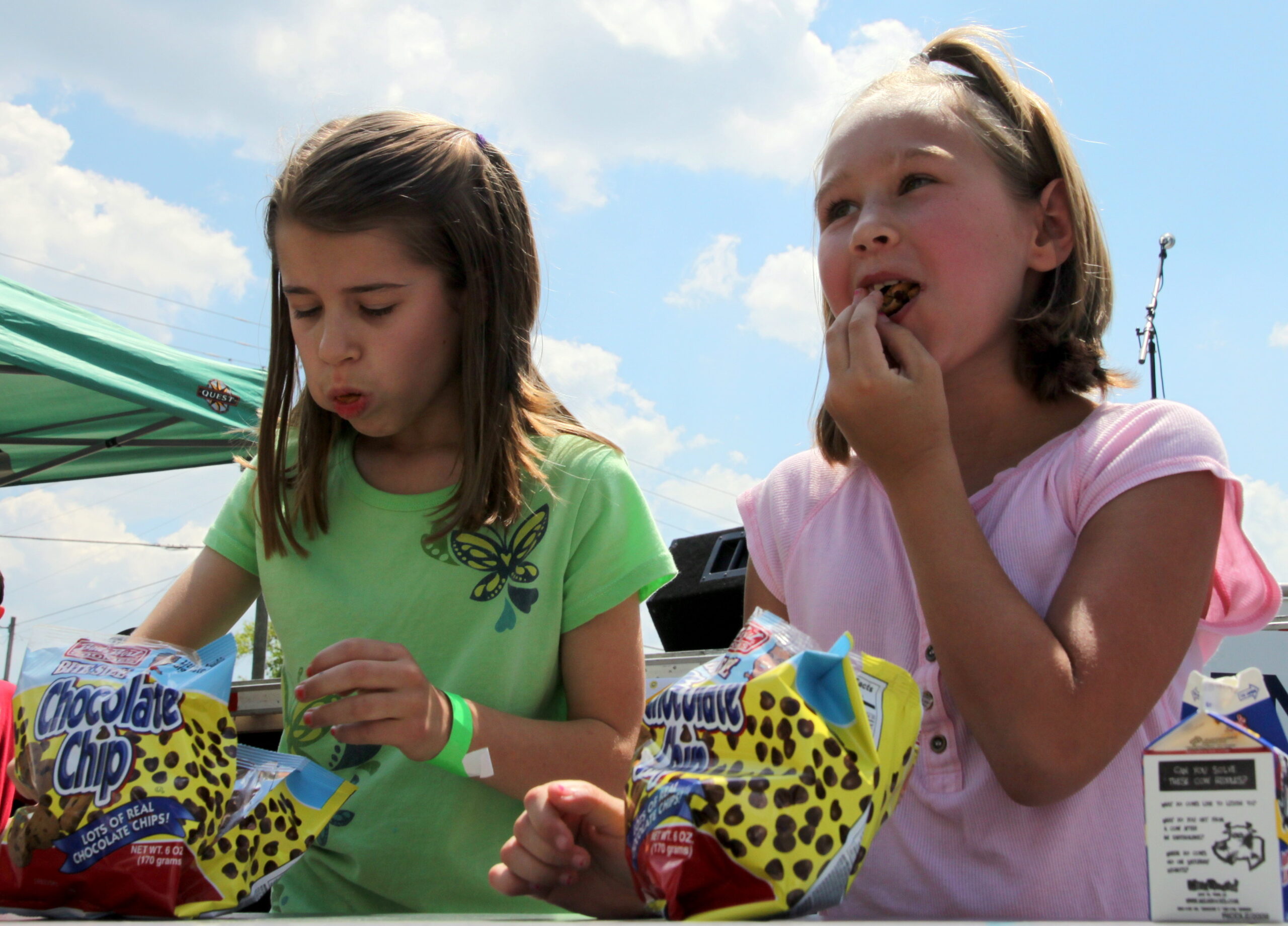 Two girls eating cookies