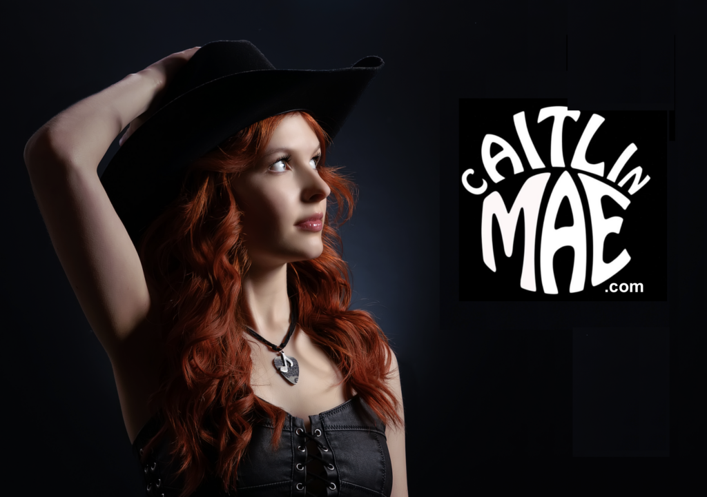 Woman with hand on back of her head with words Caitlin Mae to the side.
