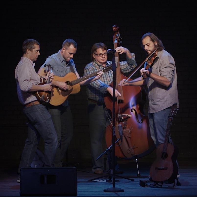 Four men playing bluegrass instruments
